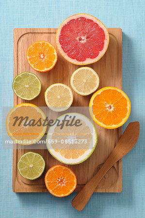 Halved citrus fruits on a wooden board Halved citrus fruits on a wooden board