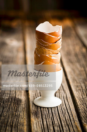A stack of empty egg shells in an egg cup