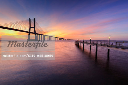 The colors of dawn on Vasco da Gama Bridge that spans the Tagus River, Lisbon, Portugal, Europe