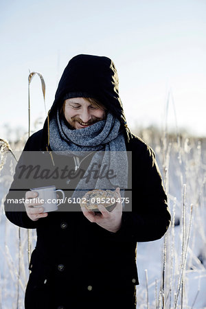 Picknick in the winter, man eating