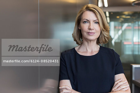 Portrait senior businesswoman with arms crossed