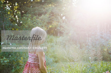 Girl standing in meadow