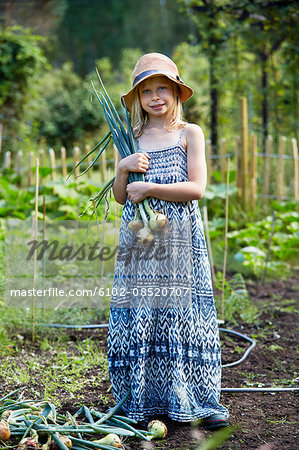 Portrait of girl holding onions