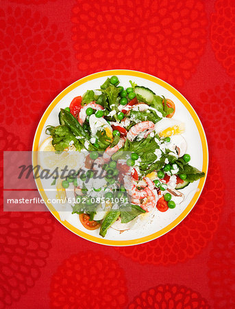 Salad with prawns on plate