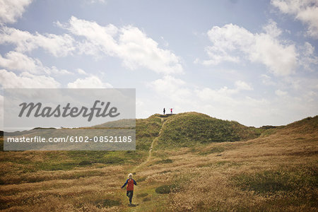 Girl running through meadow