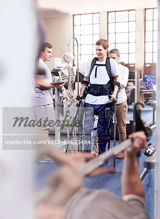 Man with forearm crutches receiving physical therapy