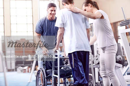 Physical therapists helping man with walker