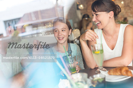 Family laughing at cafe table