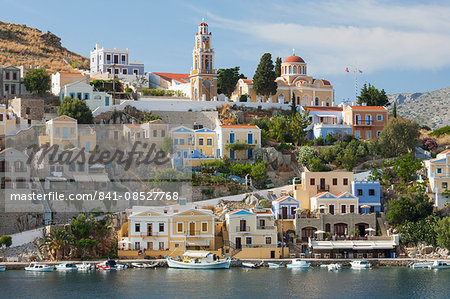 View over harbour to colourful houses and church, Gialos (Yialos), Symi (Simi), Rhodes, Dodecanese Islands, South Aegean, Greece, Europe