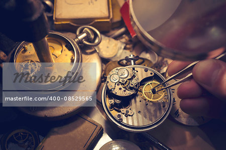 Watchmakers Craftmanship. A watch maker repairing a vintage automatic watch.