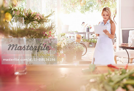 Florist doing paperwork in flower shop