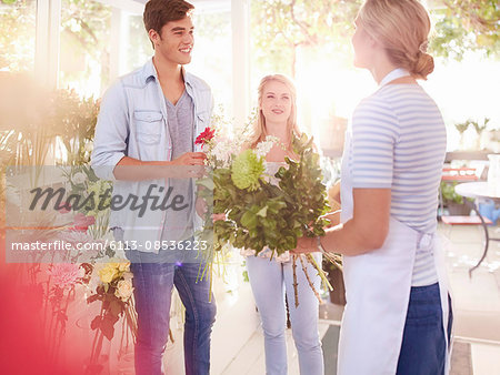 Florist helping customers select flowers in flower shop