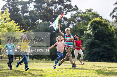 Happy children playing with a kite