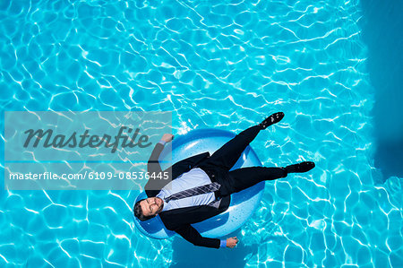 Businessman relaxing on inflatable Businessman relaxing on inflatable