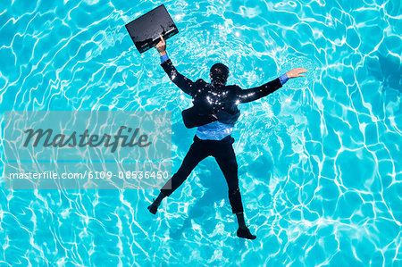 Dressed businessman in swimming pool Dressed businessman in swimming pool