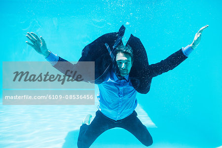 Dressed businessman in swimming pool Dressed businessman in swimming pool