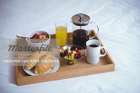 Various food and drinking on bed