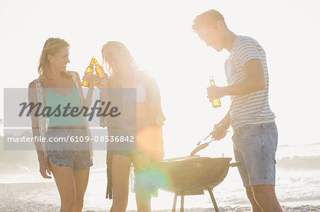 Cute group of friends having a barbecue and beers