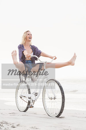 Pretty blonde woman having fun on her bicycle