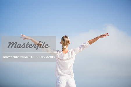 Peaceful blonde woman outstretching her arms