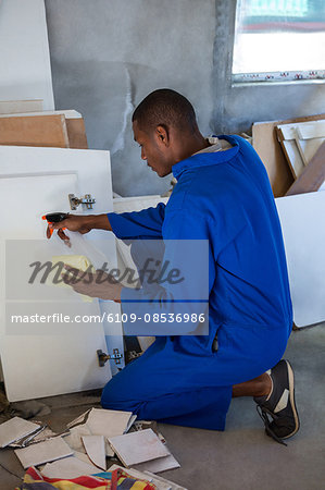 Man spraying on wooden board