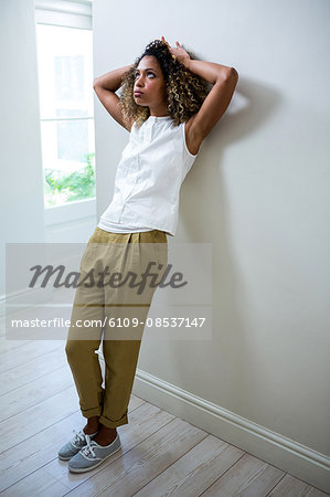 Tensed woman leaning on wall