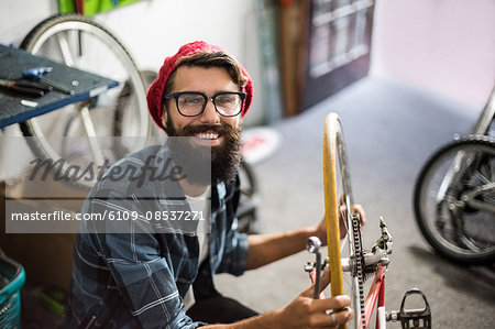 Bike mechanic checking at bicycle