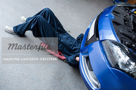 Mechanic repairing a car Mechanic repairing a car