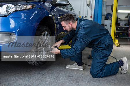 Mechanic fixing a car wheel