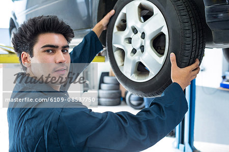 Mechanic fixing a car wheel