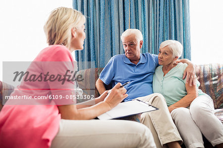 Nurse making a contract with a senior couple