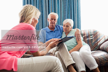 Nurse making a contract with a senior couple
