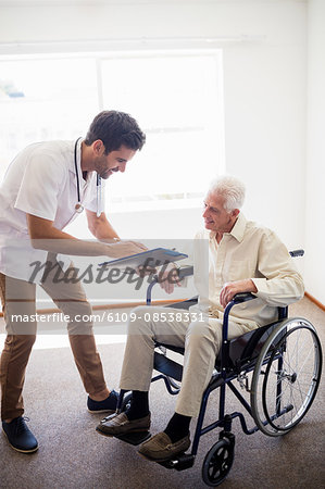 Nurse showing senior man a document