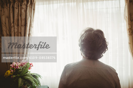 Senior woman looking out of the window