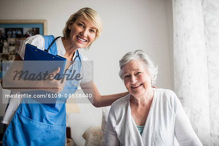 Nurse posing with a senior woman Nurse posing with a senior woman