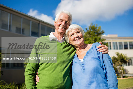 A senior couple posing together