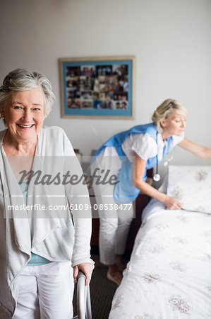 Nurse and senior woman are posing