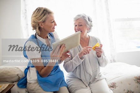 Nurse showing a tablet to a senior woman