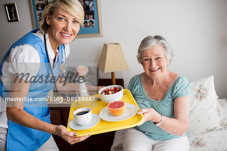 Nurse giving food to a senior woman Nurse giving food to a senior woman