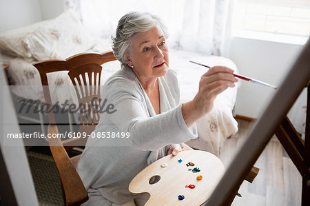 Senior woman painting