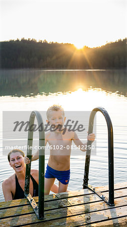 Mother and son swimming in a lake