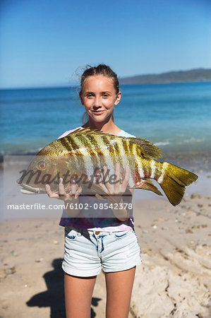 Girl holding large fish