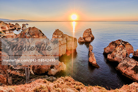 Golden sunrise on the red cliffs of Ponta Da Piedade, Lagos, Algarve, Portugal, Europe