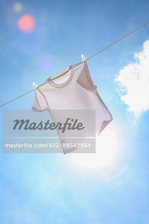 Laundry hanging against blue sky Laundry hanging against blue sky