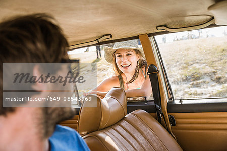 Man chatting up woman at car window on coast road, Cape Town, South Africa