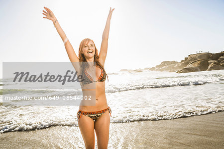 Mid adult woman wearing bikini in sea, Cape Town, South Africa