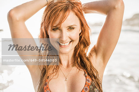 Portrait of woman with long red hair on beach, Cape Town, South Africa