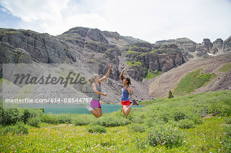 Women rejoicing in mid air, Cathedral Lake, Aspen, Colorado