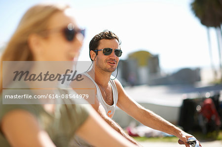 Couple cycling at Venice Beach, Los Angeles, California, USA