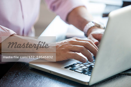 Man using laptop computer, cropped